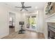 Bright exercise room boasts wood floors, ceiling fan, and French doors leading to a pool-view outdoor area at 2825 Lakeshore Dr, Mount Dora, FL 32757