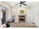 Bright exercise room boasts wood floors, ceiling fan, and a cozy fireplace feature at 2825 Lakeshore Dr, Mount Dora, FL 32757