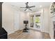 Bright exercise room boasts wood floors, ceiling fan, and French doors leading to a pool-view outdoor area at 2825 Lakeshore Dr, Mount Dora, FL 32757