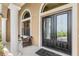 Close-up of the front door with decorative glass, stylish hardware, and a cozy seating area at 2825 Lakeshore Dr, Mount Dora, FL 32757