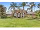 Charming home featuring mature landscaping, well manicured lawn and striking entryway at 2825 Lakeshore Dr, Mount Dora, FL 32757