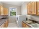 Bright laundry room features cabinetry, granite countertops, and modern washer and dryer at 2825 Lakeshore Dr, Mount Dora, FL 32757