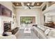 Living room with fireplace and view to pool area at 2825 Lakeshore Dr, Mount Dora, FL 32757