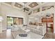 Spacious living room featuring a vaulted ceiling, fireplace, and seamless access to the backyard at 2825 Lakeshore Dr, Mount Dora, FL 32757