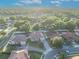 Overhead shot of homes in a lush community featuring mature trees, paved driveways, and backyard fences at 2860 Falconhill Dr, Apopka, FL 32712