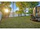 Lush green backyard with mature trees and a privacy fence at 2860 Falconhill Dr, Apopka, FL 32712