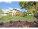 Expansive backyard featuring a pergola, mature trees, and well-maintained landscaping at 2860 Falconhill Dr, Apopka, FL 32712
