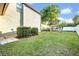 Beautiful backyard featuring lush green grass, mature trees, and a pergola at 2860 Falconhill Dr, Apopka, FL 32712