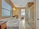 Bright bathroom featuring a soaking tub, shower, and sink with a vanity at 2860 Falconhill Dr, Apopka, FL 32712