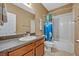 Neutral bathroom featuring a single sink vanity, ceramic floors, and a shower-tub combo at 2860 Falconhill Dr, Apopka, FL 32712
