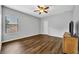 This bedroom features wood flooring and a window for natural light at 2860 Falconhill Dr, Apopka, FL 32712