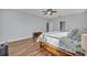 Brightly lit bedroom with wood floors and a large bed at 2860 Falconhill Dr, Apopka, FL 32712