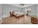Bedroom features wood floors, ceiling fan and a bright window at 2860 Falconhill Dr, Apopka, FL 32712