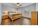 This bedroom boasts wood floors, a ceiling fan, and a window for natural light at 2860 Falconhill Dr, Apopka, FL 32712