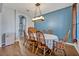 Charming dining room with hardwood floors, stylish chandelier, and comfortable seating arrangement at 2860 Falconhill Dr, Apopka, FL 32712