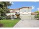Beautiful two-story home with a tile roof, green lawn, and a two-car garage at 2860 Falconhill Dr, Apopka, FL 32712