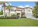 Stunning two-story home with a lush green lawn, tile roof, and attached two-car garage at 2860 Falconhill Dr, Apopka, FL 32712