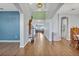 Open foyer with hardwood floors, high ceilings, and views into the living and dining spaces at 2860 Falconhill Dr, Apopka, FL 32712