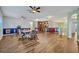 Open-concept living room with wood floors, multiple ceiling fans, and a bar area at 2860 Falconhill Dr, Apopka, FL 32712