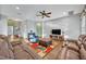 Cozy living room featuring hardwood floors, comfortable leather seating, and a ceiling fan at 2860 Falconhill Dr, Apopka, FL 32712