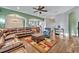 Open-concept living space with hardwood floors, comfortable sofas, and access to the kitchen at 2860 Falconhill Dr, Apopka, FL 32712