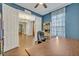 Home office featuring wooden desk, blue accent wall, and white trim and bookshelves at 2860 Falconhill Dr, Apopka, FL 32712
