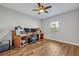 This dedicated office space features wood flooring, a ceiling fan, and a bright window at 2860 Falconhill Dr, Apopka, FL 32712