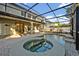 Screened-in lanai with a pool, spa, and access to the backyard at 2860 Falconhill Dr, Apopka, FL 32712