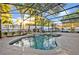 Inviting pool area inside a screened-in lanai with a spa and waterfall feature at 2860 Falconhill Dr, Apopka, FL 32712