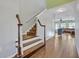 Staircase leading to the second floor with wood flooring and white railings at 2860 Falconhill Dr, Apopka, FL 32712
