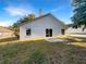 Spacious backyard featuring a well-maintained lawn, stone patio, and mature trees at 30442 Pga Dr, Sorrento, FL 32776