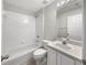 Bathroom with tub shower combo, neutral vanity, and tile flooring at 30442 Pga Dr, Sorrento, FL 32776