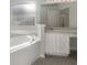 Relaxing bathroom featuring a large soaking tub, vanity, and ample natural light at 30442 Pga Dr, Sorrento, FL 32776