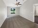 Bright bedroom with a ceiling fan, neutral paint, and serene view from the window at 30442 Pga Dr, Sorrento, FL 32776