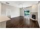 Bright living room featuring dark hardwood floors, a fireplace, sliding glass doors, and a ceiling fan at 30442 Pga Dr, Sorrento, FL 32776