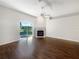 Bright living room featuring a fireplace and sliding glass doors to the backyard at 30442 Pga Dr, Sorrento, FL 32776