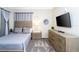 Comfortable bedroom with a mounted TV, neutral-toned furniture, and stylish decor at 3151 Paradox Cir # 108, Kissimmee, FL 34746