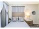 Comfortable bedroom with a gray color scheme, decorative pillows, and modern window treatments at 3151 Paradox Cir # 108, Kissimmee, FL 34746