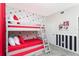Charming bedroom featuring a bunk bed with vibrant red accents and Mickey Mouse themed wallpaper at 3151 Paradox Cir # 108, Kissimmee, FL 34746