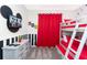 Inviting themed bedroom with a bunk bed, a TV, and playful Mickey Mouse wall decor at 3151 Paradox Cir # 108, Kissimmee, FL 34746