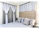 Serene bedroom with a gray color scheme, decorative pillows, and modern window treatments at 3151 Paradox Cir # 108, Kissimmee, FL 34746
