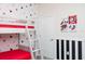 Whimsical bedroom with bunk beds, Mickey Mouse wallpaper, and striped accent wall at 3151 Paradox Cir # 108, Kissimmee, FL 34746