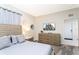 Cozy bedroom featuring a bed with gray linens, a TV, and decorative accents at 3151 Paradox Cir # 108, Kissimmee, FL 34746