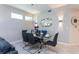 Dining room featuring modern chandelier, glass table, and decorative wall panels at 3151 Paradox Cir # 108, Kissimmee, FL 34746
