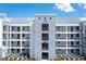 Modern condo building featuring a central entrance with multiple levels and exterior hallways at 3151 Paradox Cir # 108, Kissimmee, FL 34746