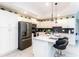 Stylish kitchen with white cabinets, stainless steel appliances, and a central island at 3151 Paradox Cir # 108, Kissimmee, FL 34746