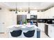 Charming kitchen with island seating, white cabinets, and modern appliances at 3151 Paradox Cir # 108, Kissimmee, FL 34746