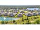 Aerial view of the neighborhood showcases houses surrounding a beautiful lake and green space at 3295 Bailey Ann Dr, Ormond Beach, FL 32174
