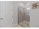 Bright bathroom shower featuring tiled walls, grab bars, and clear glass door at 3295 Bailey Ann Dr, Ormond Beach, FL 32174