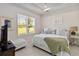 Cozy bedroom with a queen bed, soft lighting, and a large window overlooking the backyard at 3295 Bailey Ann Dr, Ormond Beach, FL 32174